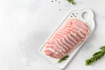 Raw pork fillet steaks with herbs and spices on white background. Butcher shop. Top view, copy space