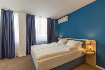 Fototapeta na wymiar Interior of a double bed hotel room interior