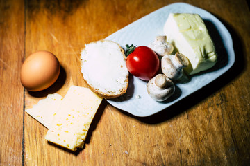 Cheese, eggs, mushrooms, tomatoes, cheese and butter with bread