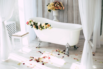 White bath with rose petals