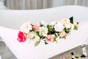 White bath with rose petals