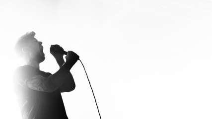Singer performing on stage at a live show