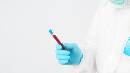 Male model with PPE suite and Hand with glove is holding blood collection tube on white background.