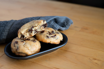 Soft and chewy chocolate chip cookies on a wooden table