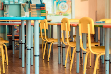 Chairs, table and toys. Interior of kindergarten. Soft selective focus.