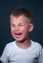 portrait of a boy with tears and resentment on his face