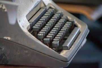 Close up photo of vintage manual typewriter being fixed by a repairman
