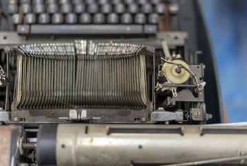 Close up photo of vintage manual typewriter being fixed by a repairman
