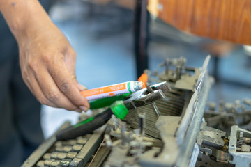 Close up photo of vintage manual typewriter being fixed by a repairman
