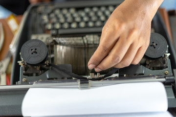 Close up photo of vintage manual typewriter being fixed by a repairman
