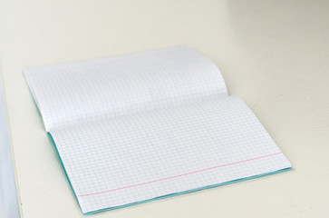 Open notebook, on white background desk, distance learning concept