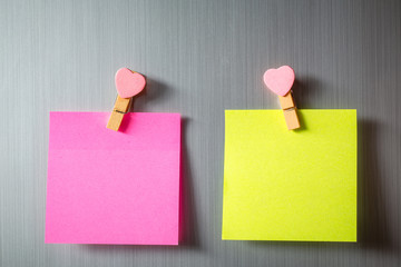 Abstract of wooden heart clip with Blank paper and stick paper on refrigerator door. paper note copy space for add text. valentine picture message background