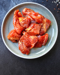 raw meat pork or beef in a plate on the table (preparing healthy food, marinade and spices paprika) menu concept background. top view. copy space for text