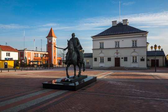 Monument and town hall on the market square in Warka, Masovia, Poland