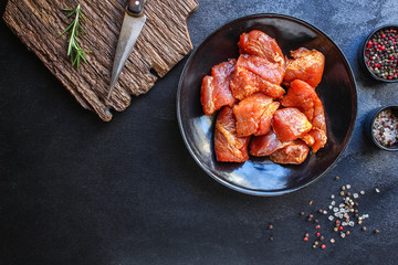 raw meat pork or beef in a plate on the table (preparing healthy food, marinade and spices paprika) menu concept background. top view. copy space for text