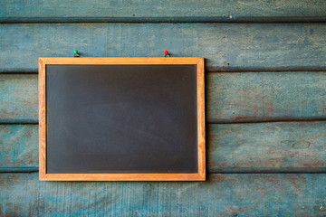 Clean chalk board on wooden wall for background. texture for educational or business background.