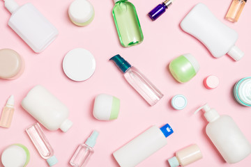 Group of plastic bodycare bottle Flat lay composition with cosmetic products on pink background empty space for you design. Set of White Cosmetic containers, top view with copy space