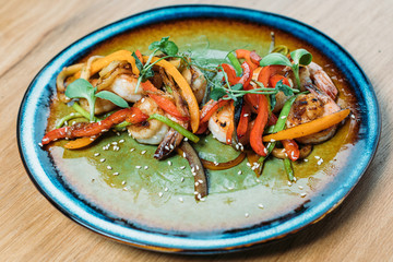 grilled prawns with vegetables on a plate in a restaurant