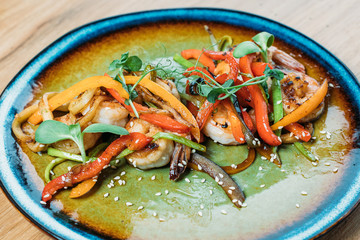 grilled prawns with vegetables on a plate in a restaurant