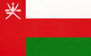 Sultanate of Oman national fabric flag, textile background. Symbol of international asian arabian world country.