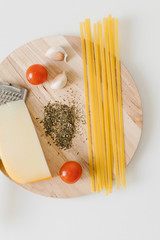 Variety of types and shapes of Italian pasta in rows on white background. Italian cuisine food. Dry pasta background texture.