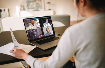 Businesswoman at home having a video conference with her team - Powered by Adobe