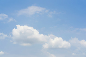 Blue sky with white soft clouds. Simple outdoor sky background.