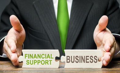 Man connects two puzzles providing financial support to business in a crisis situation. Government...