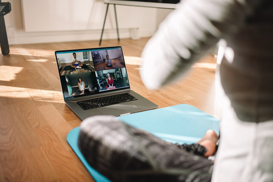 Woman conducting virtual fitness classes over video conference