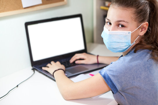 Child Webcasting With Her Laptop, Cutout White Screen And Girl Wearing One-use Medical Mask Looking At Camera