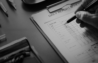 Closeup of doctor checking patient daily report checklist