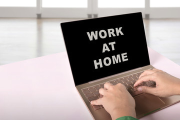 Business people using a laptop with a message for Work from home on the screen