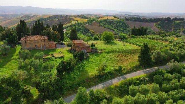 Aerial flyover the beautiful sunset landscape in Tuscany, Italy.