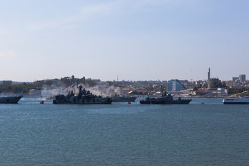 Fototapeta na wymiar Small anti-submarine ship MPK-118 Suzdalets firing from an RBU-6000 jet bomb at the parade in honor of the Navy Day in Sevastopol Bay, Crimea