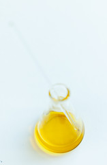 container with vegetable oil on a light background