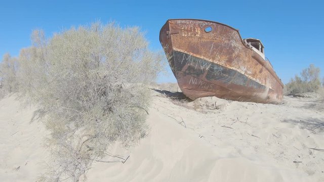Old rusty ships in the place where the Aral Sea used to be