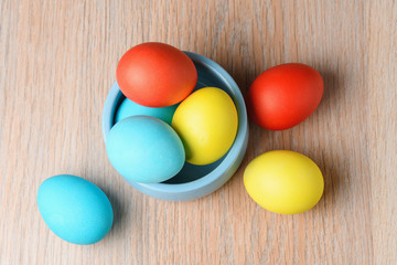 Colorful Easter eggs in a blue bowl. Easter eggs are a symbol and a mandatory attribute of Easter.