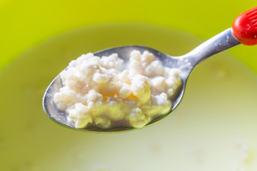 Close up of straining kefir from starter grains. Organic farm milk used for home production of...