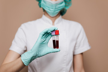 Nurse holding blood test tubes