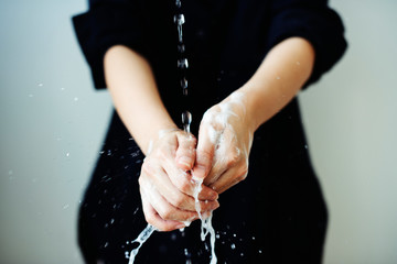 Washing hands under running water to prevent coronavirus contamination