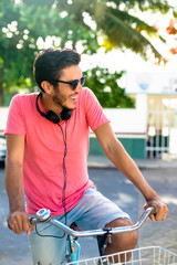 Latin urban biker with headphones - colorful mexican scene