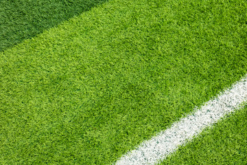 White stripe on the green soccer field from top view