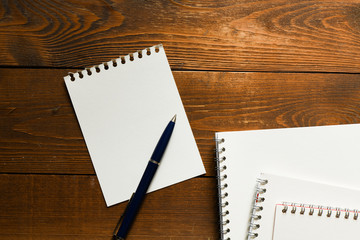 Blank notepad and on office wooden table