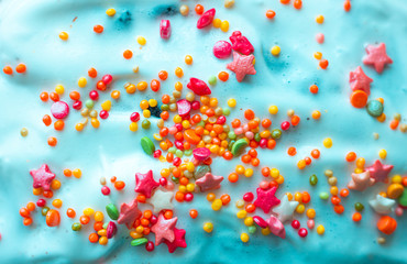 Sugar colorful candies on blue cream