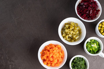 Ingredients for salad, vinaigrette on a dark background. Vegetable background.