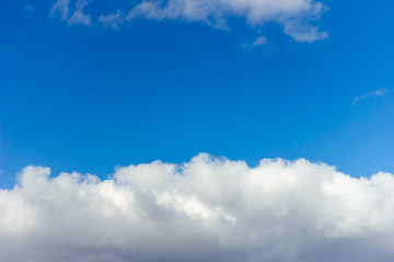 Sky background with the fluffy white clouds