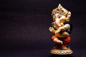 front view close up of ganesha statue on blurred background with copy space. religion and belief...