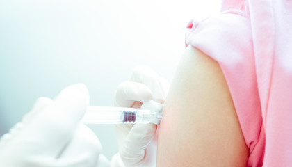 Doctor or nurses hand are adult vaccination to patient using the syringe injected upper arm for...
