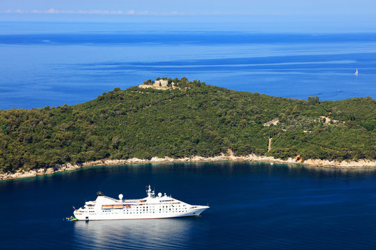 Recreational sailboat and yacht moored beside touristic Lokrum island close to Dubrovnik's Old Town harbour in Dalmatian coast of Croatia. The Adriatic sea deep blue complete this summer panorama.