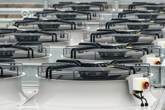 Row Of Large Industrial Fans On Condenser Of Ammonia NH3 Or Co2 Refrigeration System Used For Cooling Chillers And Freezers